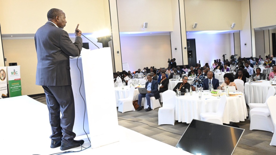 The Finance Minister addressing delegates from the lectern at the 15th National Competitiveness Forum.