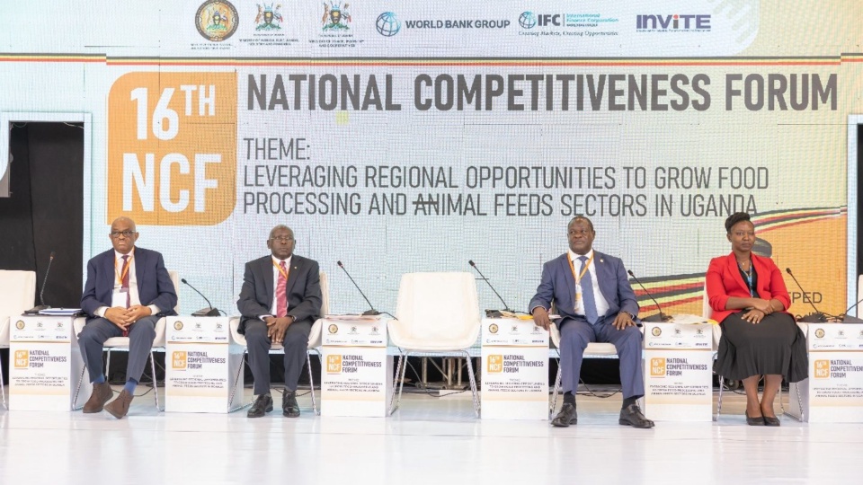 Panellists seated on stage at the 16th National Competitiveness Forum, in front of a backdrop carrying the Forum theme.