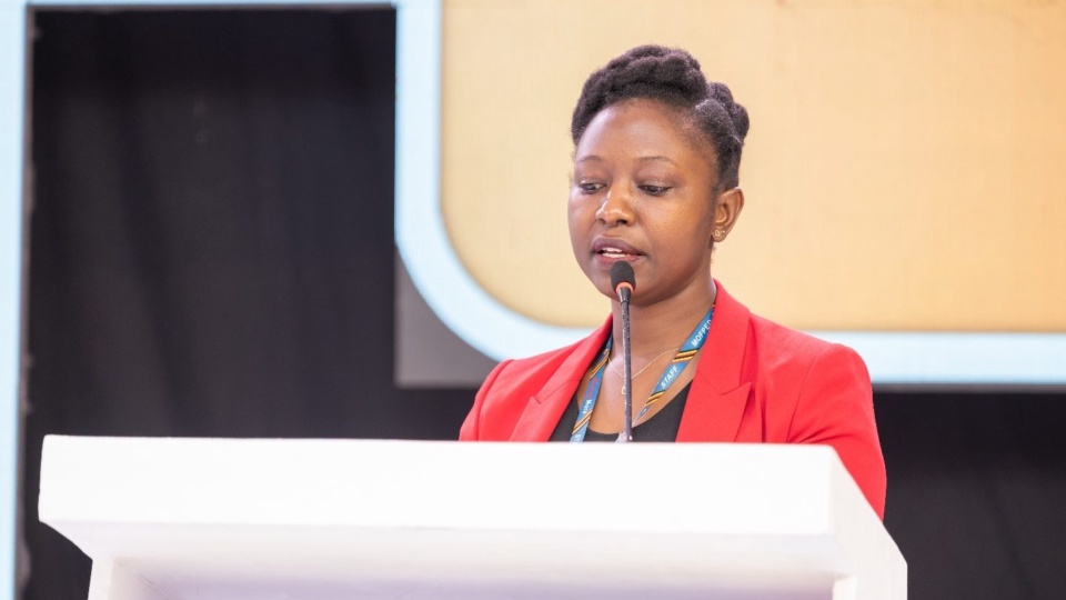 The Head of the Private Sector Development Unit speaking from the lectern.