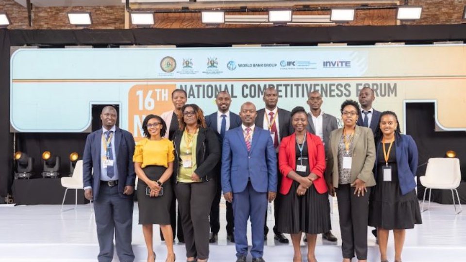 Members of the organising team standing together on stage for a group photograph.